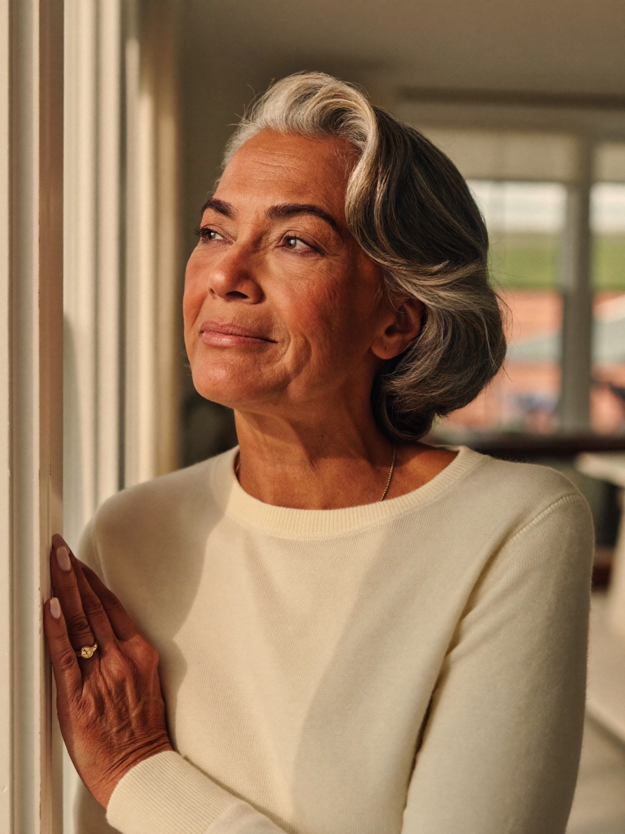 A woman in her sixties at home, calm and confident about her retirement plan
