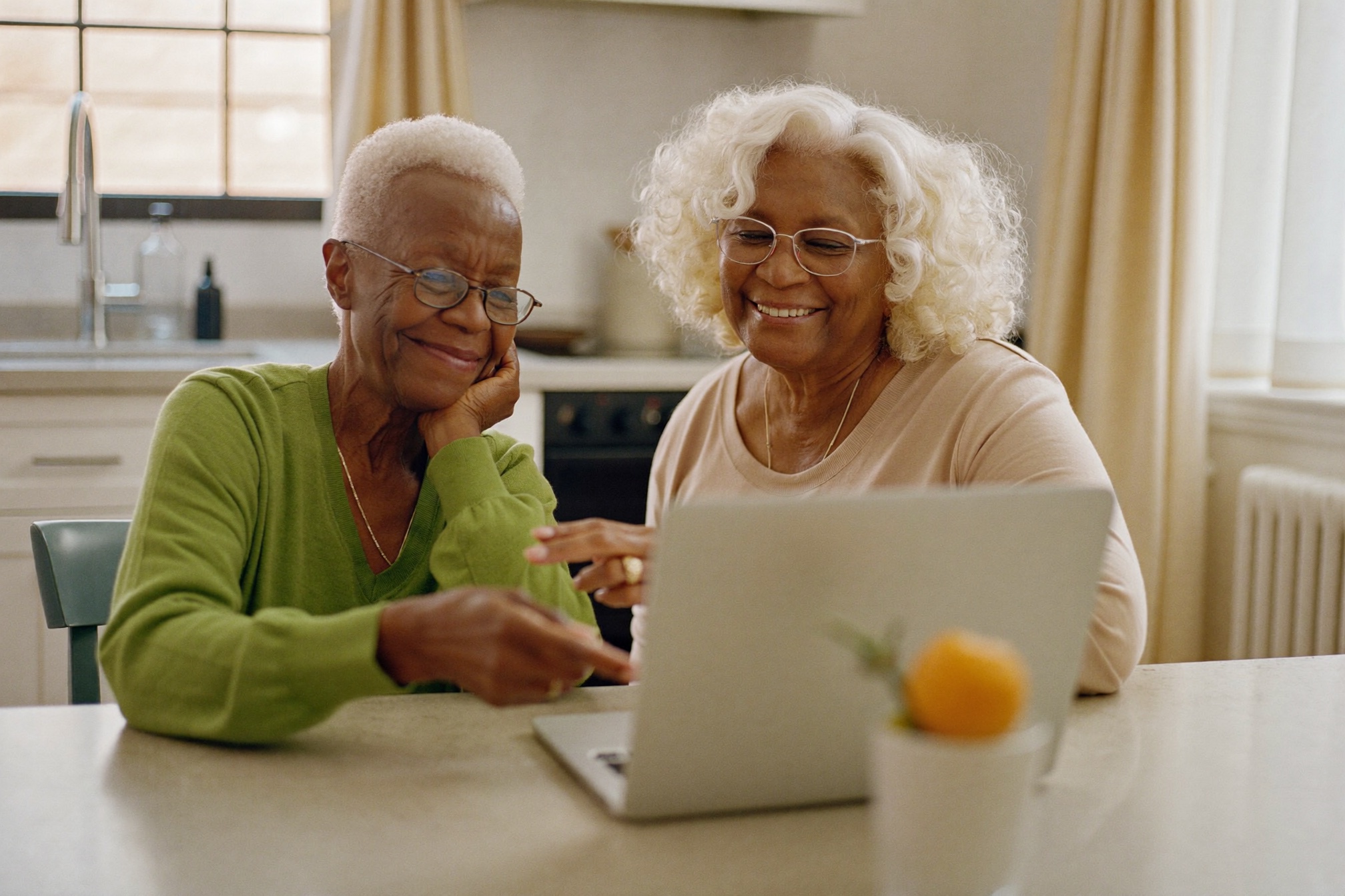 A retired couple meeting their adviser from home over a video call